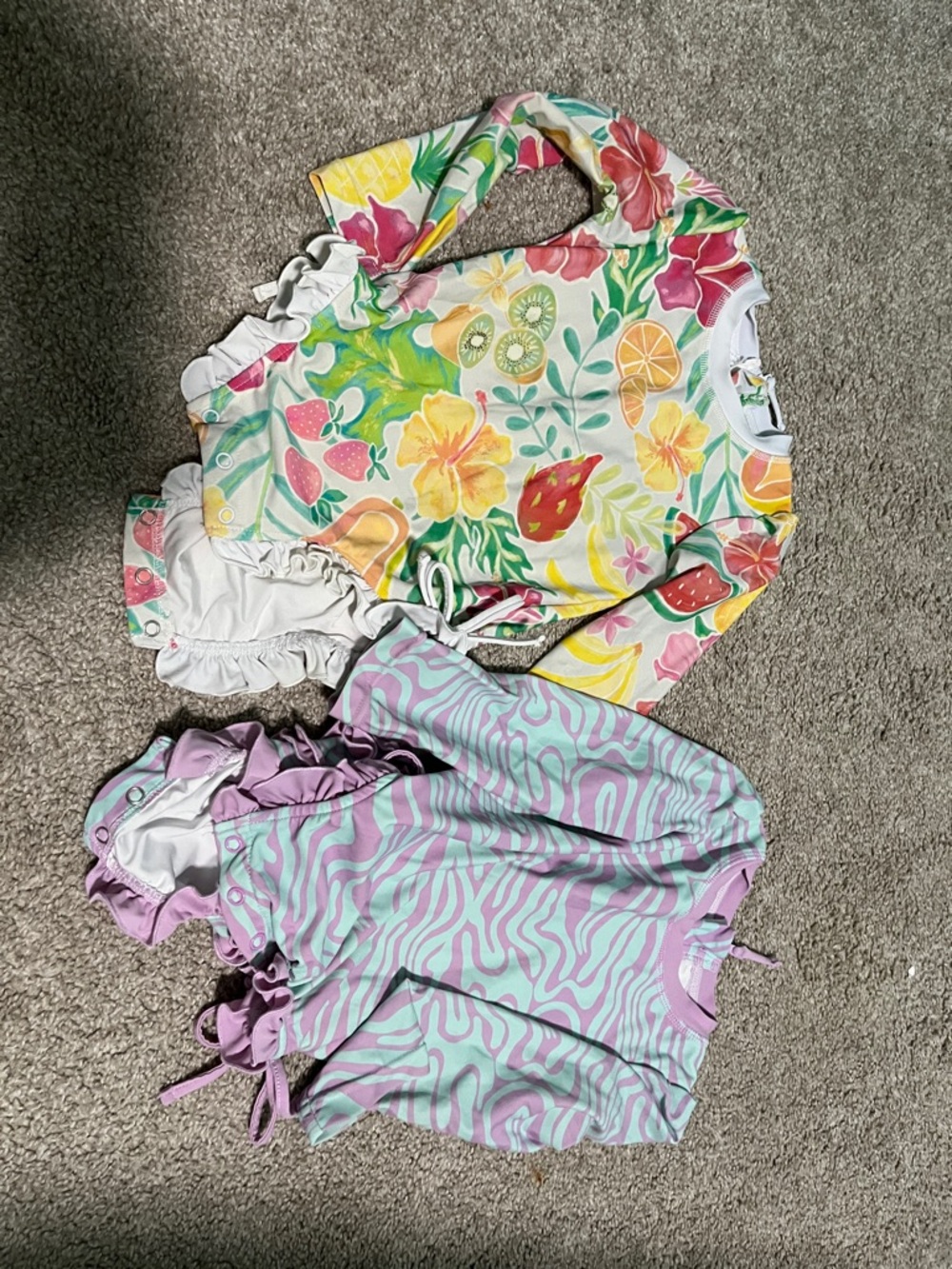 Two Caden Lane Rashguards with ruffle butts and snaps on bottom